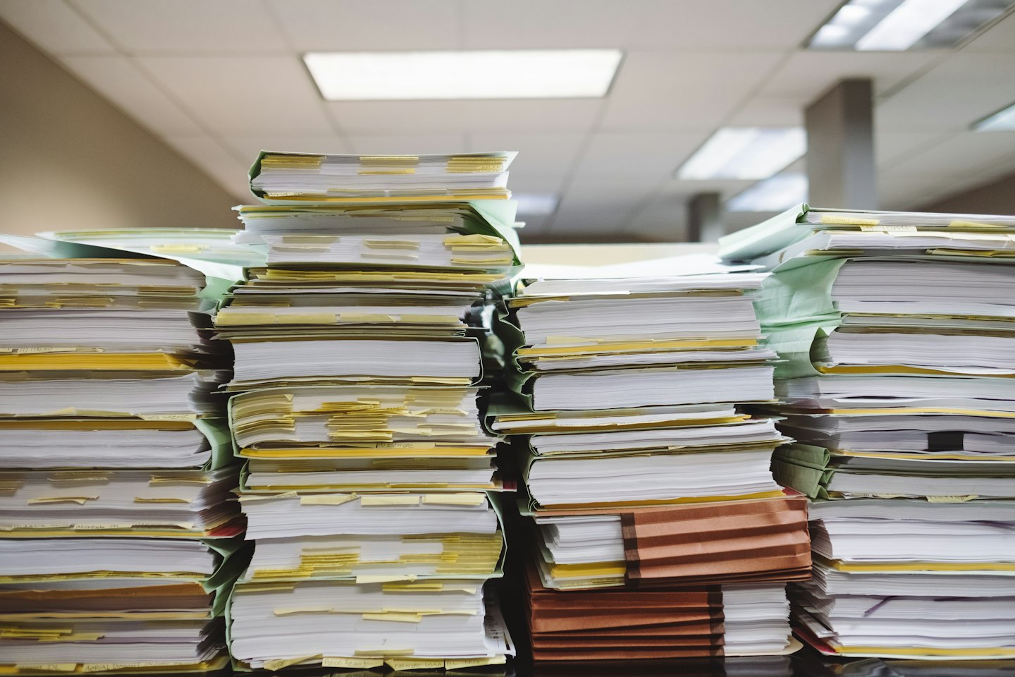 Stacks of documents and files in accordion folders.